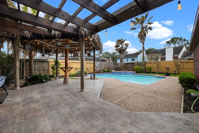 view of pool featuring a patio area, a fenced backyard, and a pergola