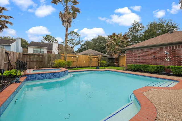 view of swimming pool featuring a fenced backyard, a fenced in pool, and an in ground hot tub