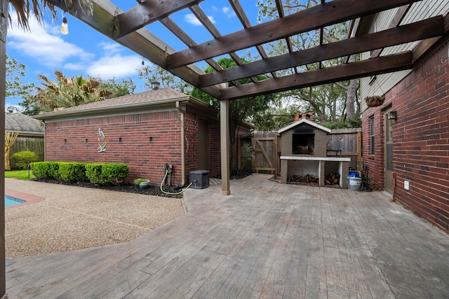 view of patio / terrace featuring central AC, fence, and a pergola