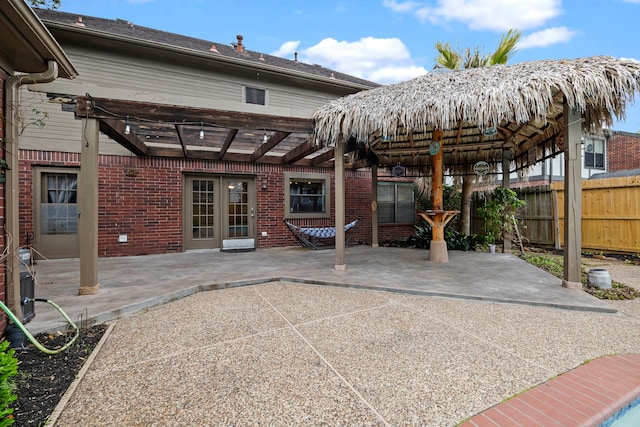 view of patio / terrace with a gazebo, french doors, and fence