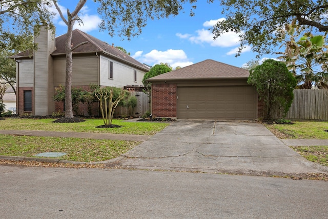 traditional-style home featuring brick siding, fence, concrete driveway, a chimney, and a front yard