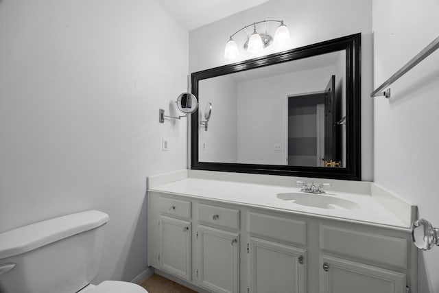 half bathroom with toilet and vanity