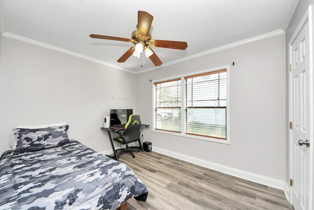 bedroom featuring baseboards, ceiling fan, light wood-style floors, and crown molding