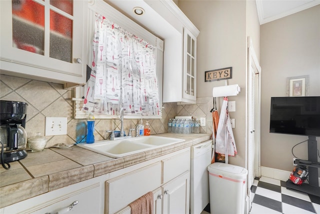 kitchen with tile counters, glass insert cabinets, tile patterned floors, white cabinetry, and a sink