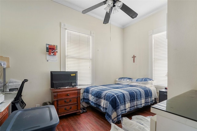 bedroom featuring ceiling fan, ornamental molding, and dark wood-type flooring