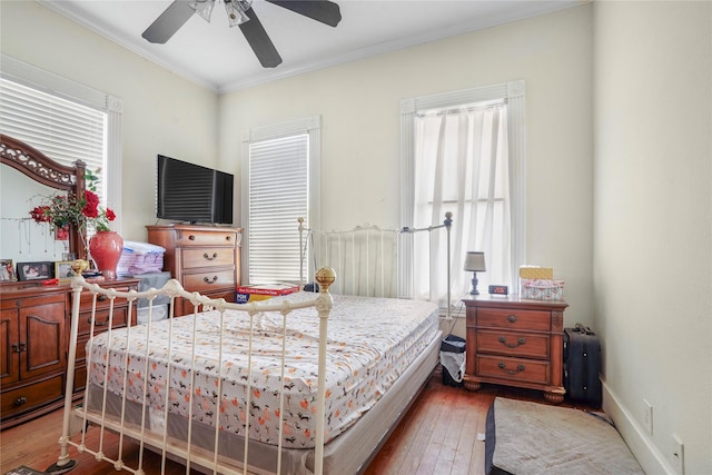 bedroom featuring ornamental molding, ceiling fan, and hardwood / wood-style floors