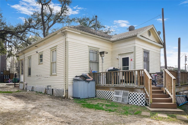 rear view of property with crawl space and a wooden deck