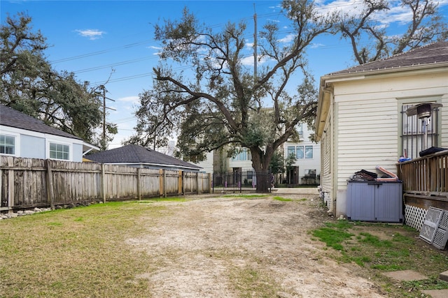 view of yard with driveway and fence