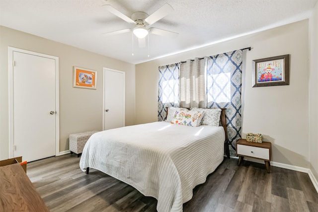 bedroom featuring a ceiling fan, a textured ceiling, baseboards, and wood finished floors