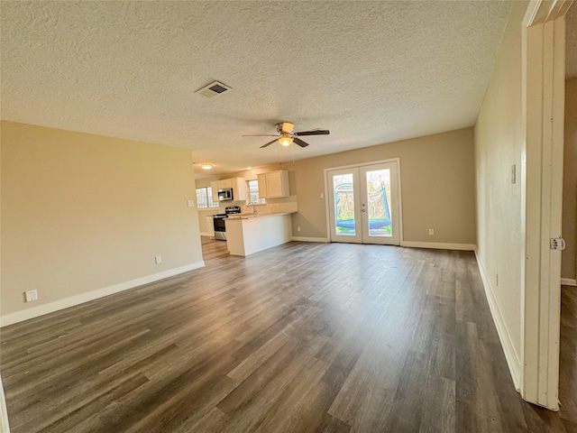 unfurnished living room with ceiling fan, french doors, dark wood finished floors, and baseboards