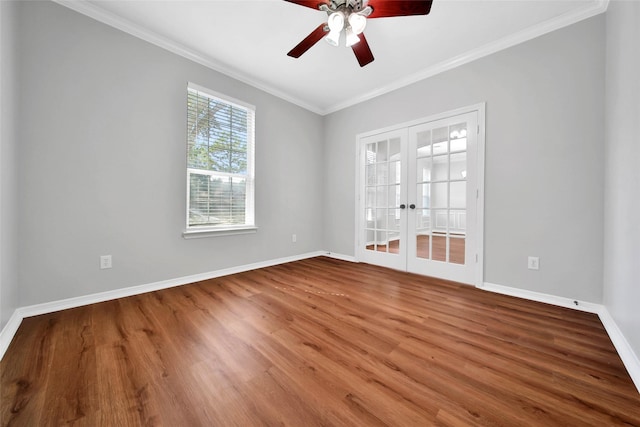 empty room featuring ornamental molding, french doors, baseboards, and wood finished floors