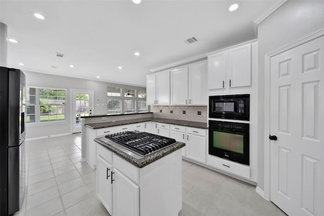 kitchen with recessed lighting, a peninsula, white cabinets, backsplash, and black appliances