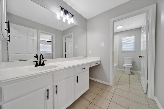 full bathroom with toilet, tub / shower combination, vanity, tile patterned flooring, and baseboards