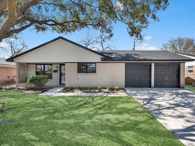 view of front of home with a front yard, concrete driveway, brick siding, and an attached garage