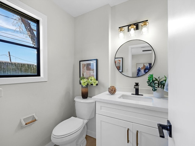 half bathroom featuring toilet and vanity