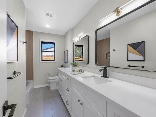 bathroom featuring visible vents, toilet, a sink, tile patterned flooring, and baseboards