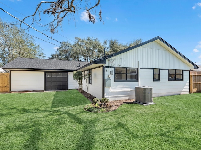 view of home's exterior with fence, central AC, and a yard