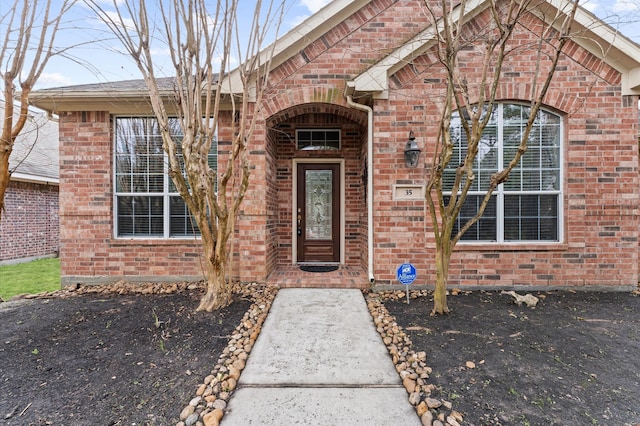 doorway to property with brick siding