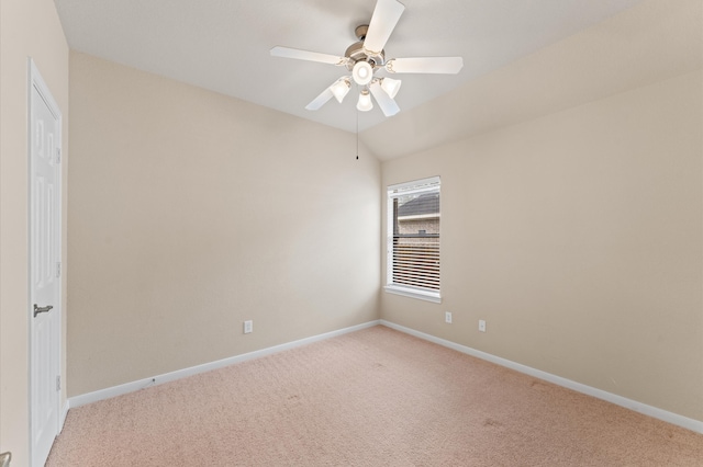 empty room with ceiling fan, baseboards, vaulted ceiling, and light colored carpet