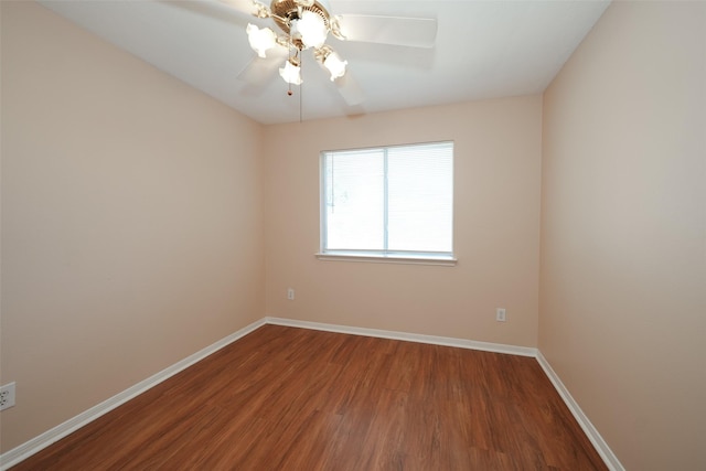 unfurnished room featuring a ceiling fan, baseboards, and wood finished floors