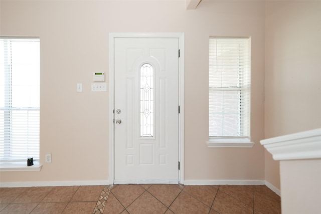 tiled foyer entrance with a wealth of natural light and baseboards