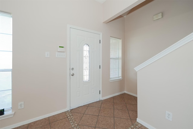 entrance foyer with baseboards and tile patterned floors