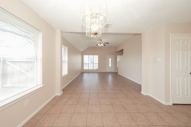 spare room featuring light tile patterned floors, ceiling fan with notable chandelier, visible vents, baseboards, and vaulted ceiling