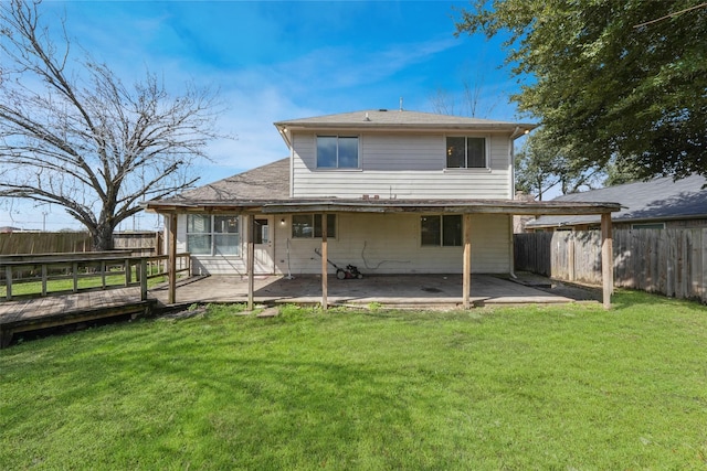 rear view of property with a patio area, a fenced backyard, a yard, and a deck