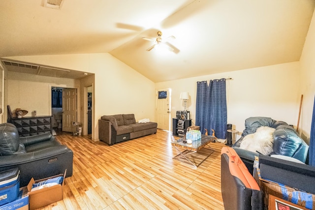 living room with a ceiling fan, visible vents, vaulted ceiling, and wood finished floors