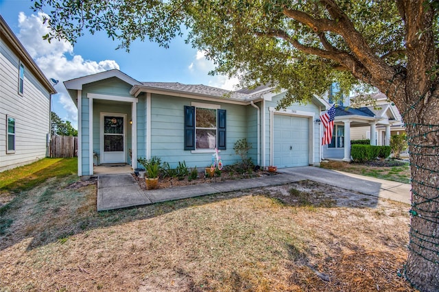 view of front of property with a garage, driveway, fence, and a front yard