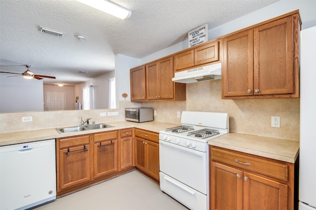 kitchen featuring light countertops, white appliances, and under cabinet range hood