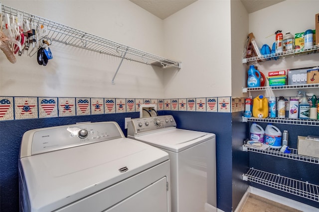 clothes washing area featuring laundry area and separate washer and dryer