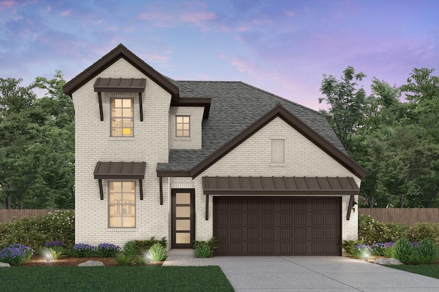 view of front of property with a shingled roof, concrete driveway, an attached garage, a standing seam roof, and fence