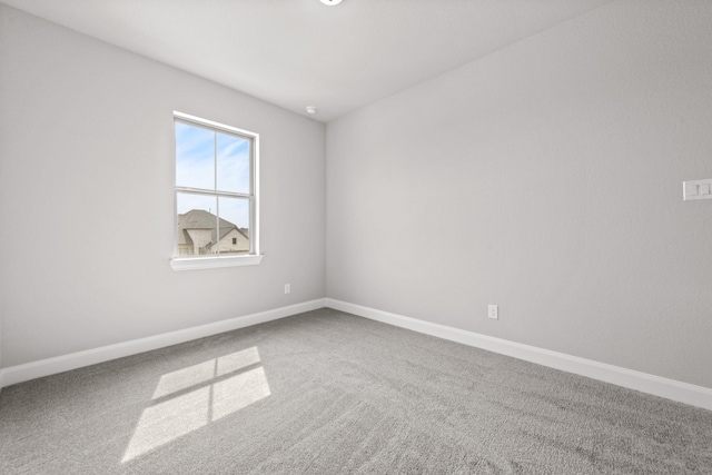 carpeted empty room with baseboards