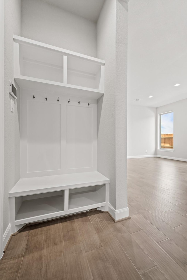 mudroom featuring baseboards and wood finished floors