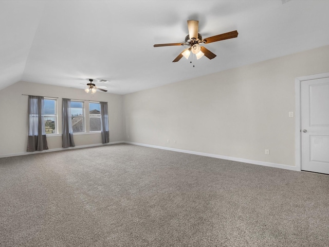 unfurnished room featuring a ceiling fan, baseboards, vaulted ceiling, and carpet flooring