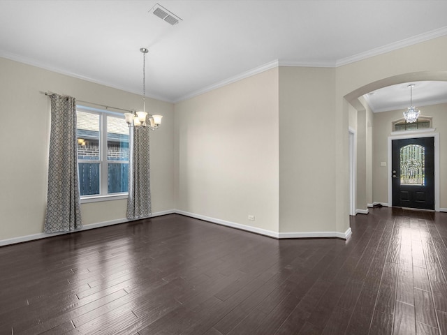 entryway featuring an inviting chandelier, arched walkways, and dark wood finished floors