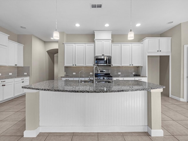 kitchen featuring appliances with stainless steel finishes, visible vents, a sink, and light tile patterned flooring