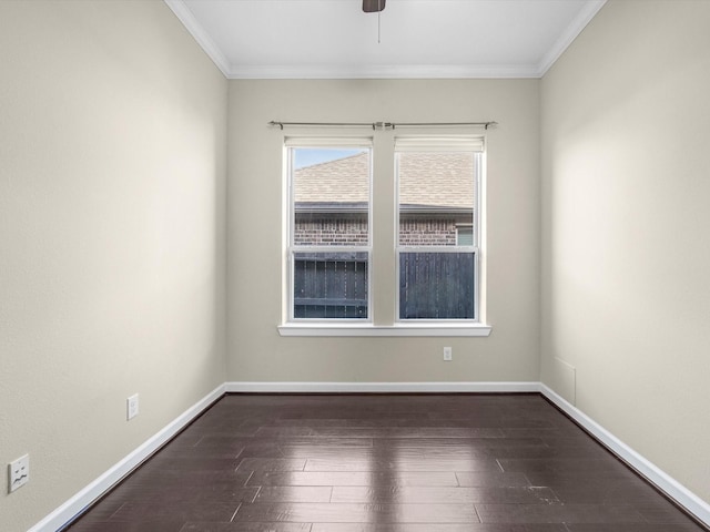 spare room featuring ornamental molding, dark wood finished floors, baseboards, and ceiling fan