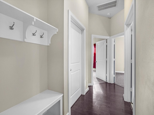 mudroom featuring dark wood-style floors and visible vents