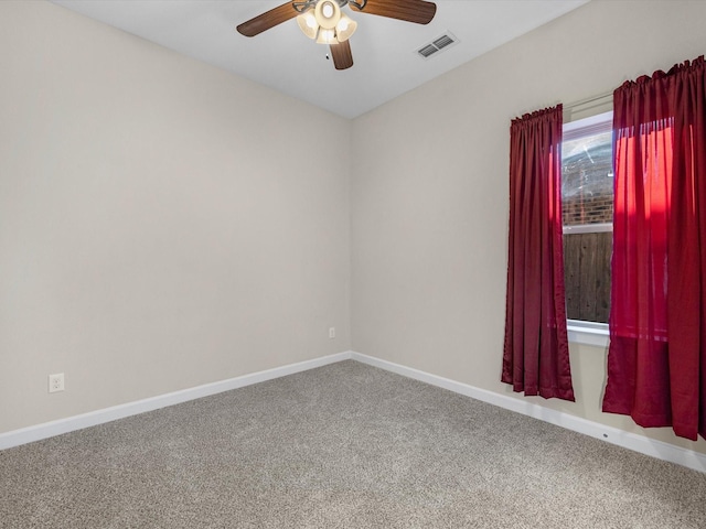 unfurnished room featuring baseboards, visible vents, ceiling fan, and carpet flooring