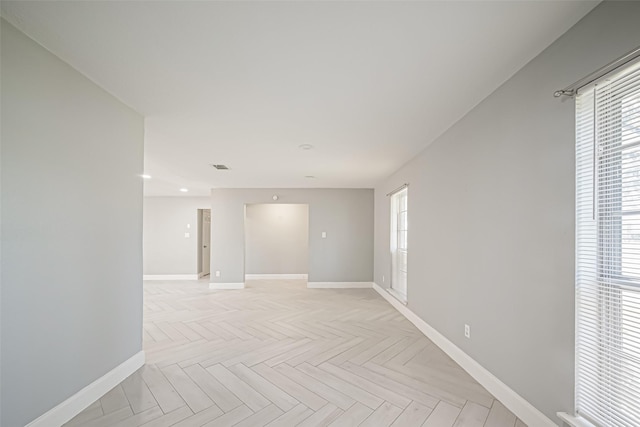 spare room with visible vents and baseboards