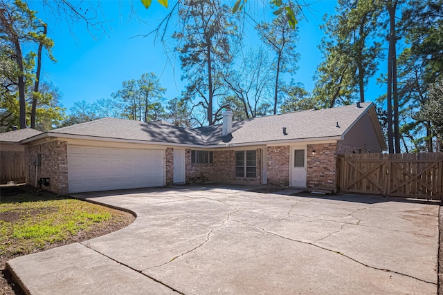 ranch-style house featuring a garage, concrete driveway, a chimney, fence, and brick siding