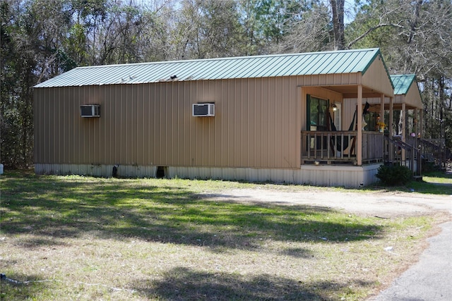 view of home's exterior featuring metal roof and a lawn