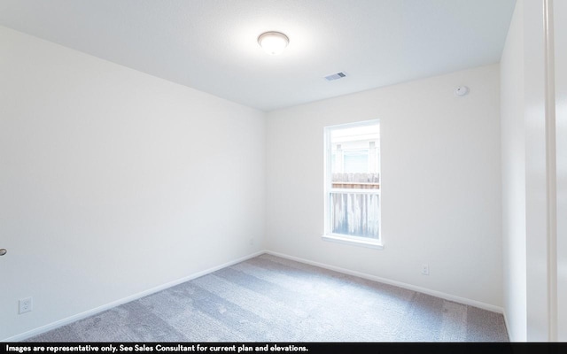 carpeted empty room with visible vents and baseboards