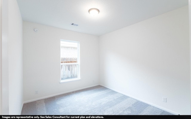 spare room with carpet, visible vents, and baseboards
