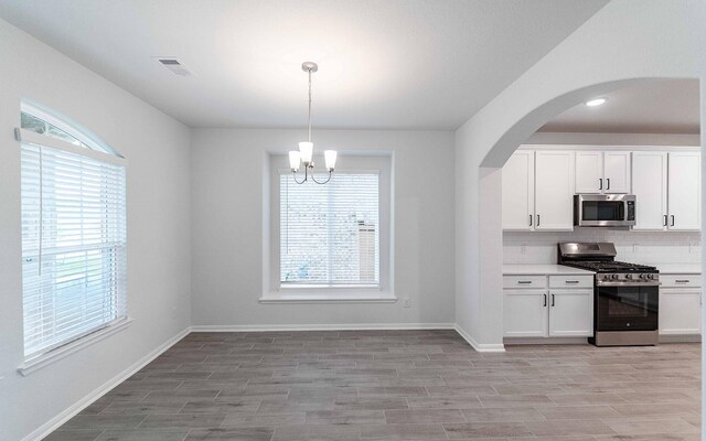 13709 Seneca Lake Dr, Texas City, TX 77568 - kitchen with stainless steel appliances, healthy amount of natural light, tasteful backsplash, and light wood finished floors