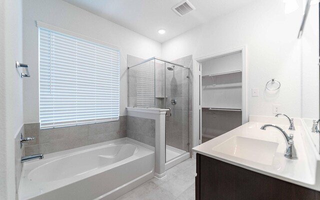 13709 Seneca Lake Dr, Texas City, TX 77568 - full bathroom with a garden tub, a shower stall, a walk in closet, and double vanity