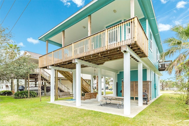 rear view of property with stairway, a deck, a patio, and a yard