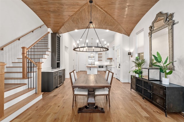 dining area with stairs, wine cooler, light wood-type flooring, and wood ceiling